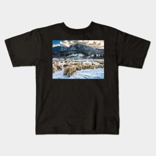 Flock of sheep at the bottom of the mountain Kids T-Shirt